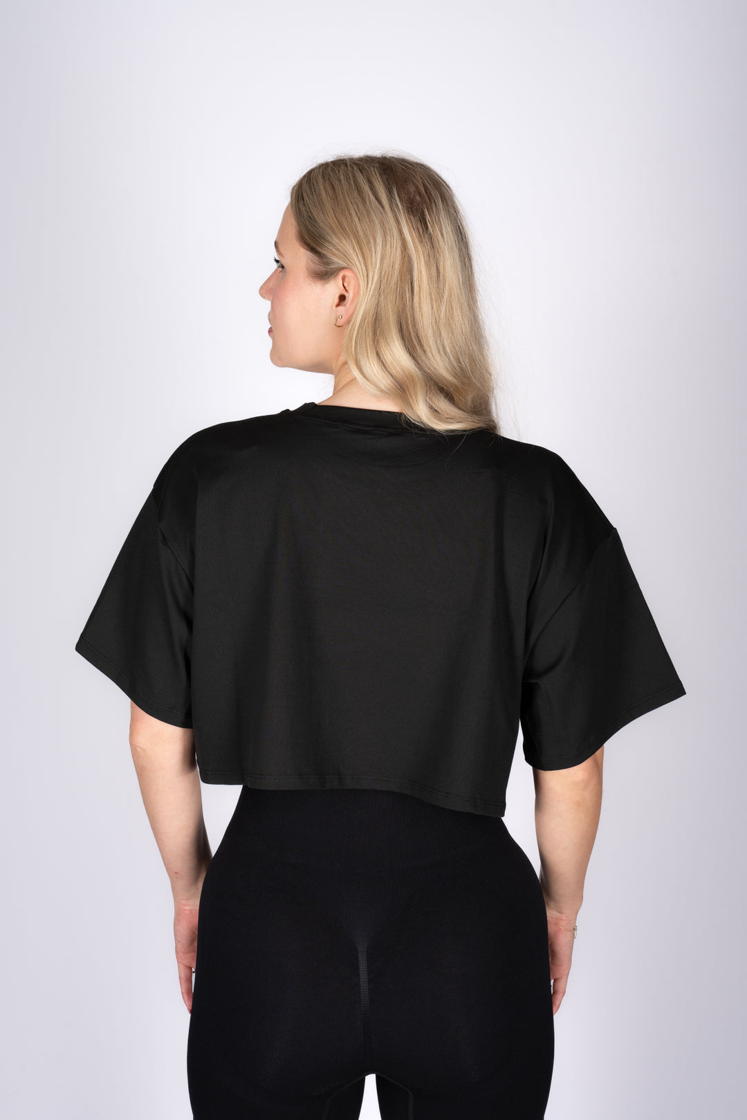 Fitted black crop top side view