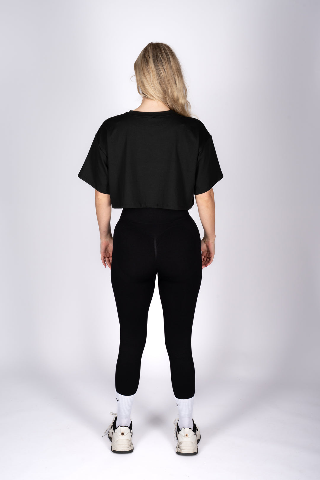 Basic black leggings flat lay on white background